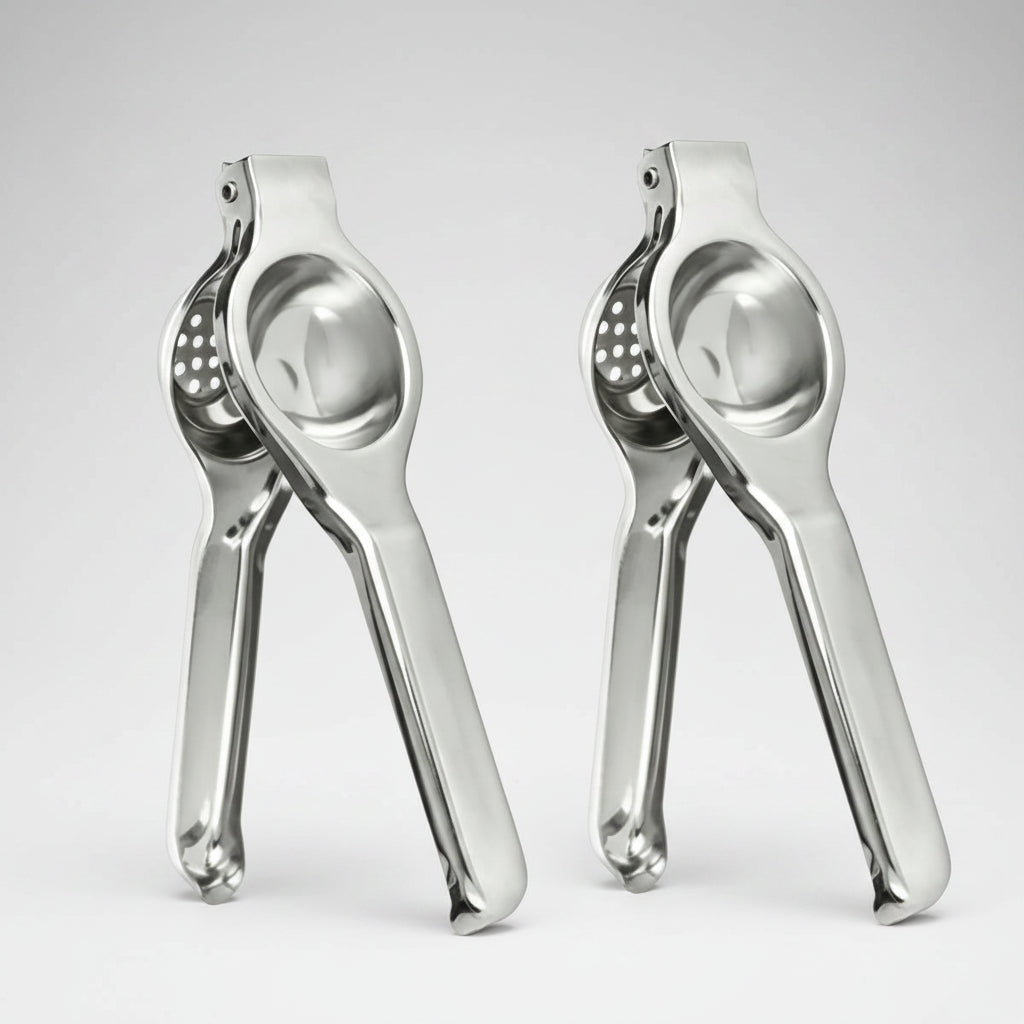 Two silver garlic pressers on a white background