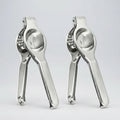 Two metal garlic presses on a white background