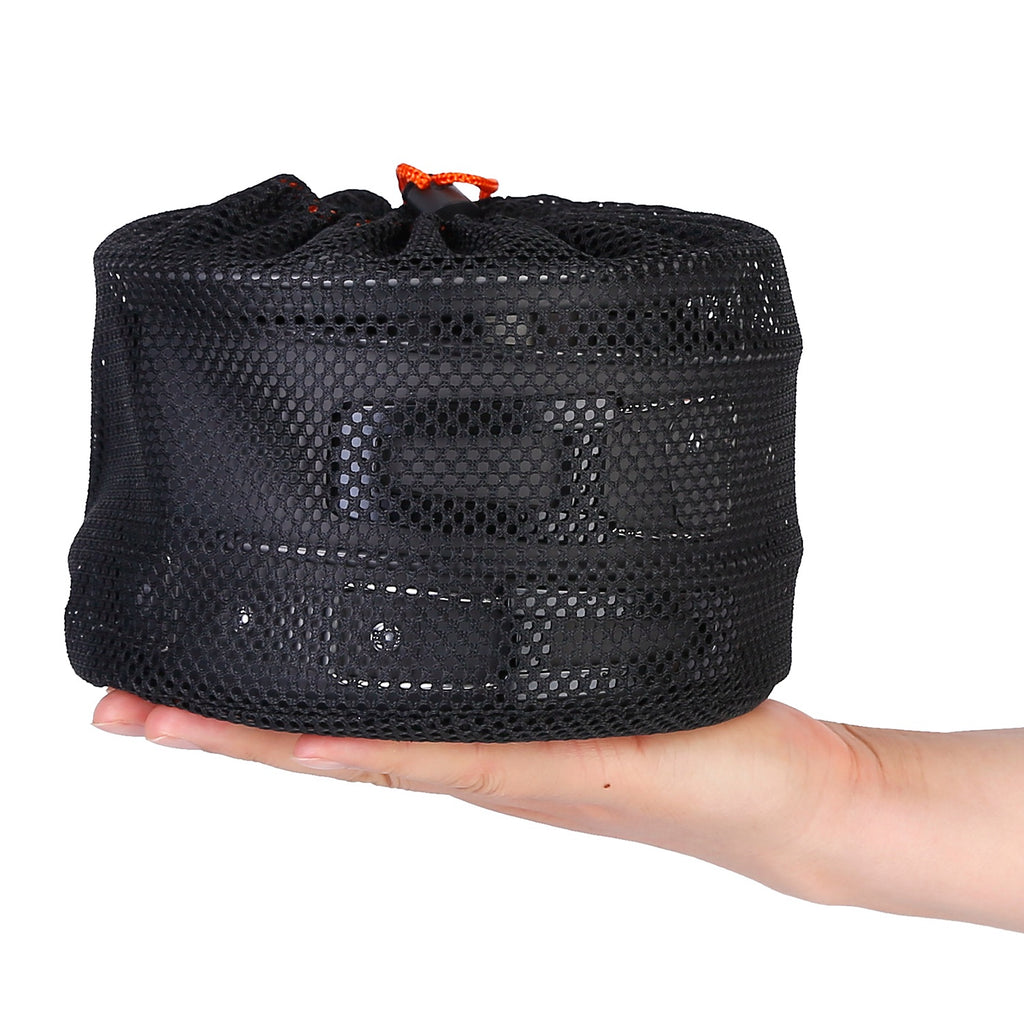 Black mesh bag held in a hand on a white background